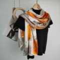 Elegant orange and white silk scarf with luxury carriage print, versatile long fashion neck wrap. - Vintage Key Woven Patch