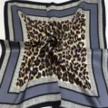 Classic square silk scarf with leopard print center and grey geometric borders, stylish accessory. - Brown and Gray Leopard Print Scarf