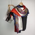 Luxury silk satin scarf for women, featuring a vibrant floral and geometric print design. - Fiery Red and Light Blue