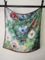 Detailed view of a square oil painting floral print silk scarf hanging with vivid flower patterns. - Monet Anemone
