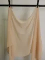 Detail view of lightweight pure color chiffon scarf, elegant drape for spring and summer wear. - Apricot