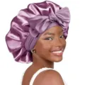 Detail view of the purple satin sleep bonnet featuring a bow and double-layer hair care design. - 58cm Head Circumference (One Size) / Purple