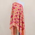 Detailed view of the thick floral embroidered cashmere-feel shawl with vibrant pink flowers. - Color 092
