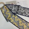 Double-sided silk twilly scarf featuring floral and paisley prints with a wooden ring. - Gilded Blue Flowers