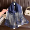 Close-up detail view of dark blue silk scarf featuring elegant pearl and rhinestone floral design. - 74.8*27.5inch / Navy Blue