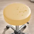 Tabouret roulant rond avec coussin en cuir imperméable jaune clair et base chromée à roulettes. - Beige