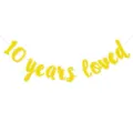 Close-up detail of the gold glitter 10 years loved banner string, perfect for celebration party. - 10 Years Loved Glitter Garland