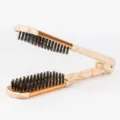 Wood grain V-shaped hair straightening brush with boar bristles and gold metal accents for styling. - Gold