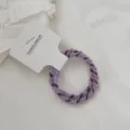 Detailed close-up of a twisted purple hair tie set with candy color elastic material. - 2 Pieces/Pack / Purple