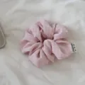 Detail closeup shot of a cute pink checkered hair scrunchie featuring tag and fabric. - Style 7 Pink Plaid