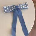 Blue denim hair bow featuring delicate white lace trim and long streamers for sweet styles. - Streamer Bowknot Hair Clip