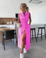 Pink sleeveless denim midi dress detail, belted waist and button-up design in modern setting. - Rose Red