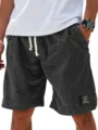 Men's casual linen shorts summer loose beach drawstring shorts with classic label design - S / Black