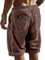 Detailed view of men's brown corduroy shorts back pocket label and textured fabric. - S / Pink
