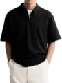 Close-up view of the black textured half-zip polo shirt with turn-down collar and short sleeves. - L / Black