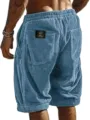 Detail view of men's blue corduroy casual shorts with drawstring and back pocket woven label. - S / Sky Blue