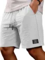 Detailed view of men's casual drawstring shorts pocket and fabric texture closeup design - S / White