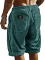 Detailed close-up view showing the back pocket design and textured corduroy fabric of the men's shorts. - S / Malachite green