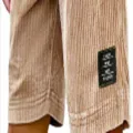 Corduroy shorts detail view showcasing textured fabric and a stylish black label accent. - S / Khaki