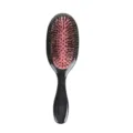 Black oval cushion hairbrush with boar bristles and pink pad for smooth daily hair styling. - S