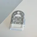 Close-up detail of the grey star patterned 3-inch photocard holder and pendant album. - 3 Inch Photo Album / Light Gray