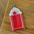 Close-up of red white checkered photocard holder with apple pattern and cute bead chain. - Apple 3-Inch Card Sleeve