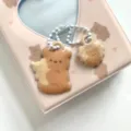 Close-up detail of cute bear double-sided acrylic keychain charm with white beaded chain. - Milk Tea Colored Bear Pendant Charms