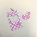 Pink checkered acrylic photocard holder detail with heart cutout and cherry pattern keychain. - Pink Plaid Cherry Card Sleeves