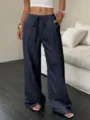 Detail view of casual textured navy blue wide-leg trousers with high waist and drawstring. - XS / Dark Blue