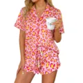 Close-up detail of women's pink leopard print short-sleeve pajama shirt and ruffle shorts. - Pink