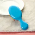 Mini cepillo de pelo portátil con cerdas de colores vibrantes y cojín antiestático para niños. - Azul marino