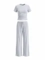 Detailed view of grey casual two-piece lounge set, featuring a ruched crop top and wide pants. - XS / Top And Bottom / Light Gray