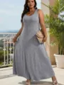 Close-up detail of the elegant sleeveless grey plus-size maxi dress worn in a sunny outdoor setting. - 3XL / Dark Heather Gray