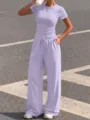 Detailed view of the casual lavender two-piece set featuring a short sleeve top and wide leg pants. - XS / Top And Bottom / Light Purple