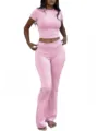 Close-up detail of the stylish pink cropped t-shirt and low-waist flared pants set. - XS / Top And Bottom / Light Pink