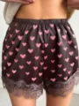 Detailed view of women satin shorts featuring pink heart print and delicate lace trim. - S / Bottoms / Reddish Brown (Heart Shape)