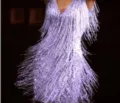 Sparkling fringe dress detail showing the shimmering lavender texture and movement. - Violet