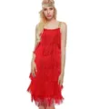 Close-up detail of the red fringe dress, featuring multi-layer tassels and gold straps. - S / Red