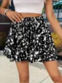 Detailed view of the stylish black and white abstract print drawstring shorts skirt for women. - S / Black