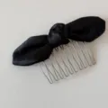 Detailed shot of black satin ribbon hair comb with silver metal teeth for elegant hairstyles. - Black Knotted Bowknot - Hair Comb