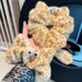 Detailed view of fluffy leopard print cat hair scrunchie with cute googly eyes for daily wear. - Coffee Cat Hair Tie