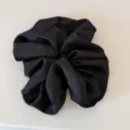 Black satin hair scrunchie detail view, elegant voluminous hair tie accessory for women. - Black Hair Tie