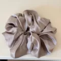 Close-up detail shot of a plush satin hair scrunchie, soft texture and elegant sheen. - Light Gray Scrunchie