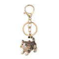Leuke getijpte kat sleutelhanger met glinsterende strass-steentjes en gouden ring. - Zwarte Stijl
