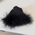 Black feather hair claw clip detail shot, elegant plush texture for charming hairstyles. - Black