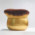 Detailed view of the soft dense synthetic bristles and golden ergonomic egg-shaped handle. - Gold