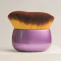 Detailed close-up of the soft bristled cosmetic brush with purple base and dense wavy hairs. - Purple