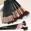 Detail view of the 15-piece makeup brush set featuring soft bristles and sleek black handles. - 15 Pieces / Black