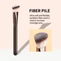 Detailed view of the angled foundation makeup brush showcasing soft synthetic bristle fibers. - Brown