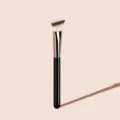 Detailed shot of an angled foundation brush with soft bristles and sleek black handle. - Black & Gold